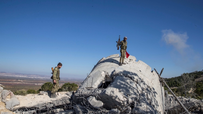 The image shows members of the Free Syrian Army on patrol.