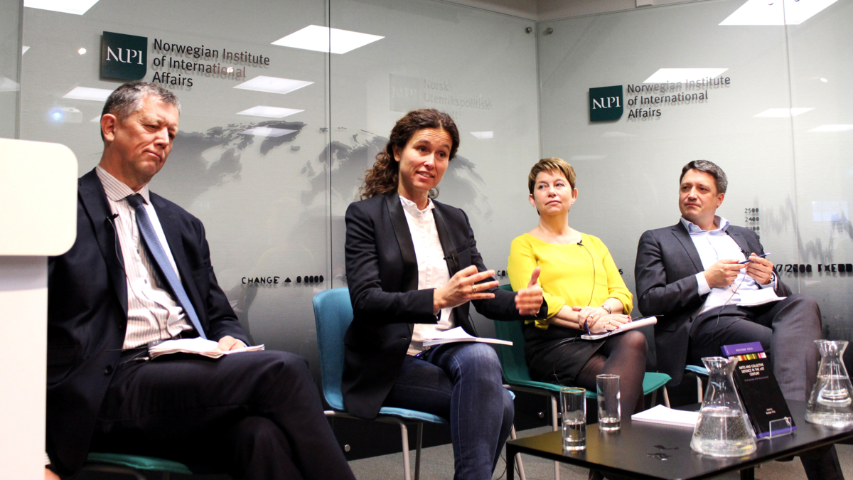 The image shows a panel at a NUPI event